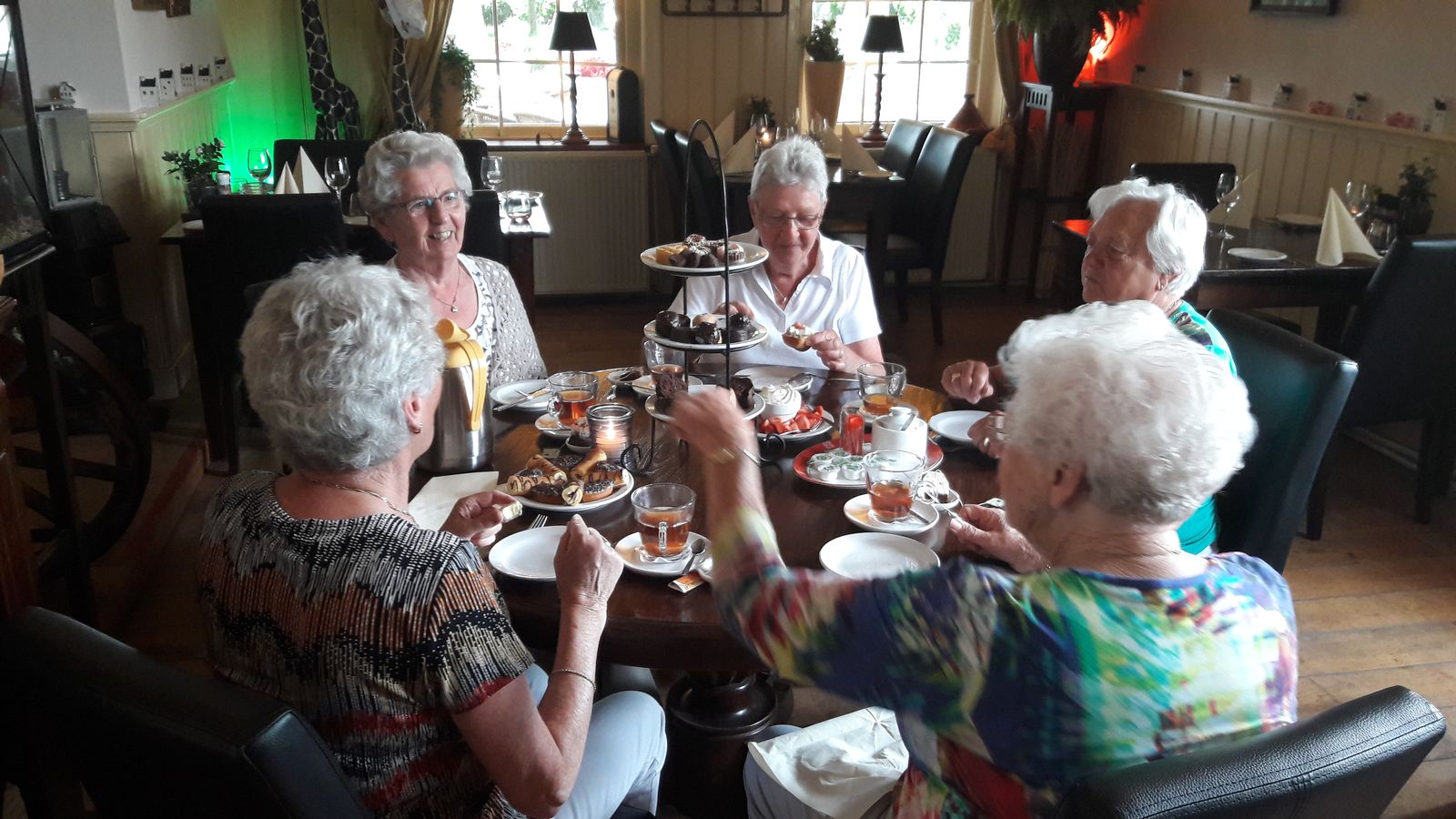 Gezelschap geniet van een high tea